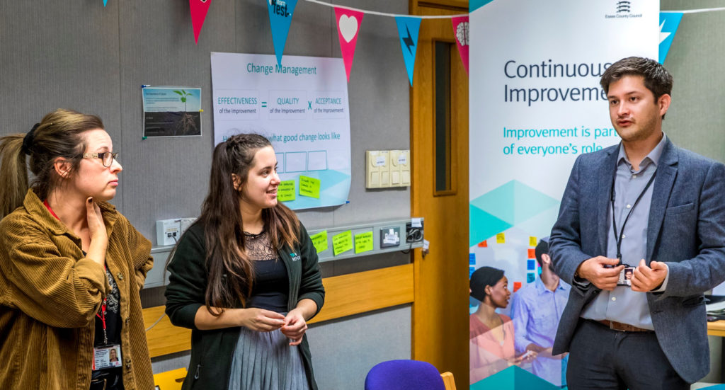 Two women listing to a man talking.